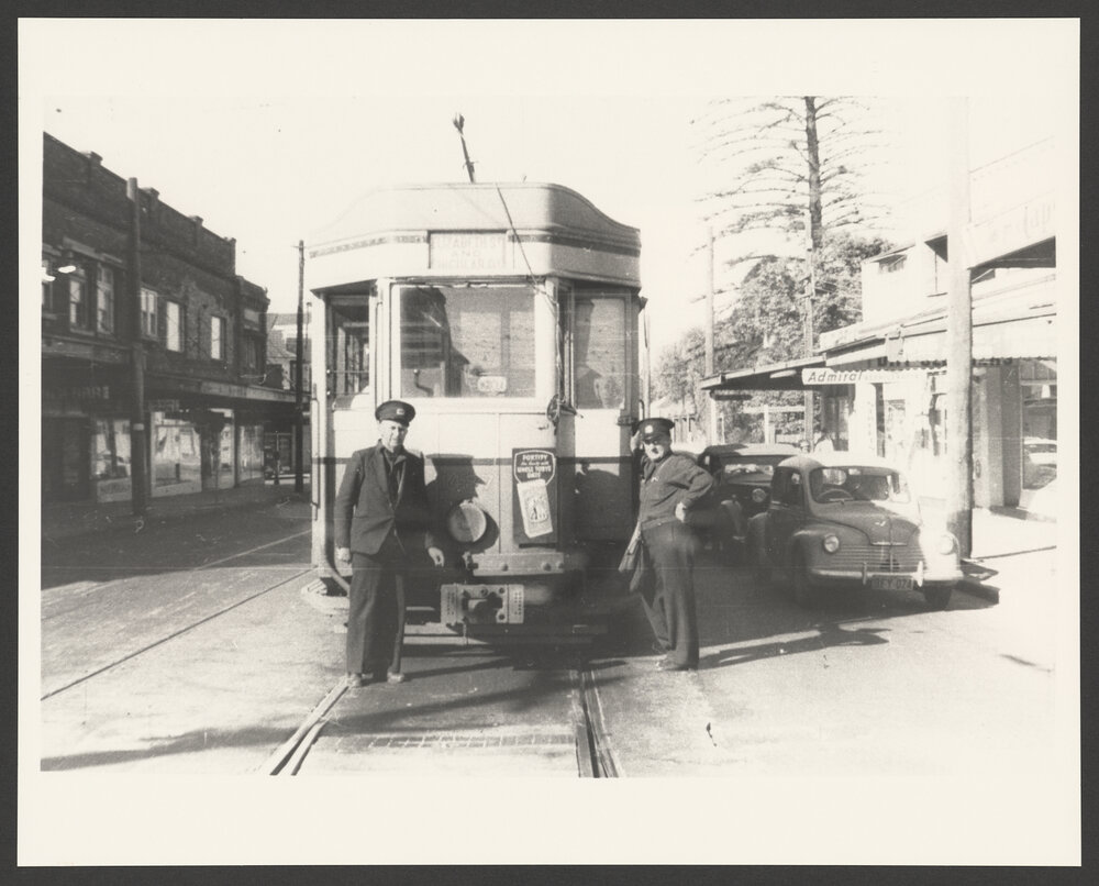 Tram driver, left, and conductor, stand in front of P class tram, Oxford street at Waverley tram depot tram stop.