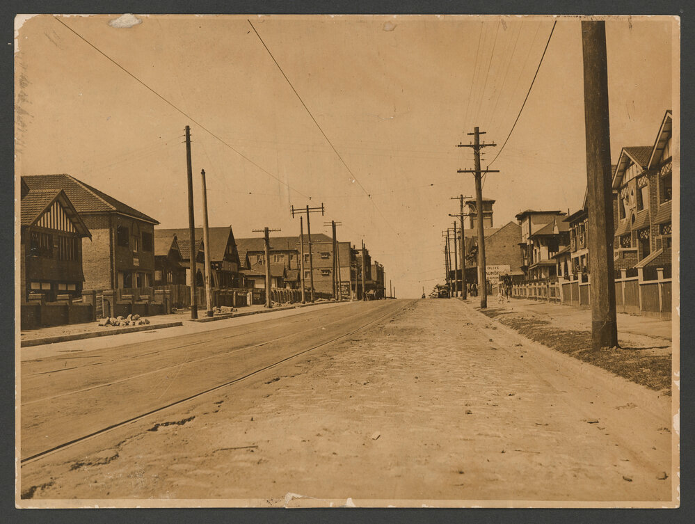 Curlewis Street, Bondi, with tram tracks. Bondi Hotel clock tower, background.