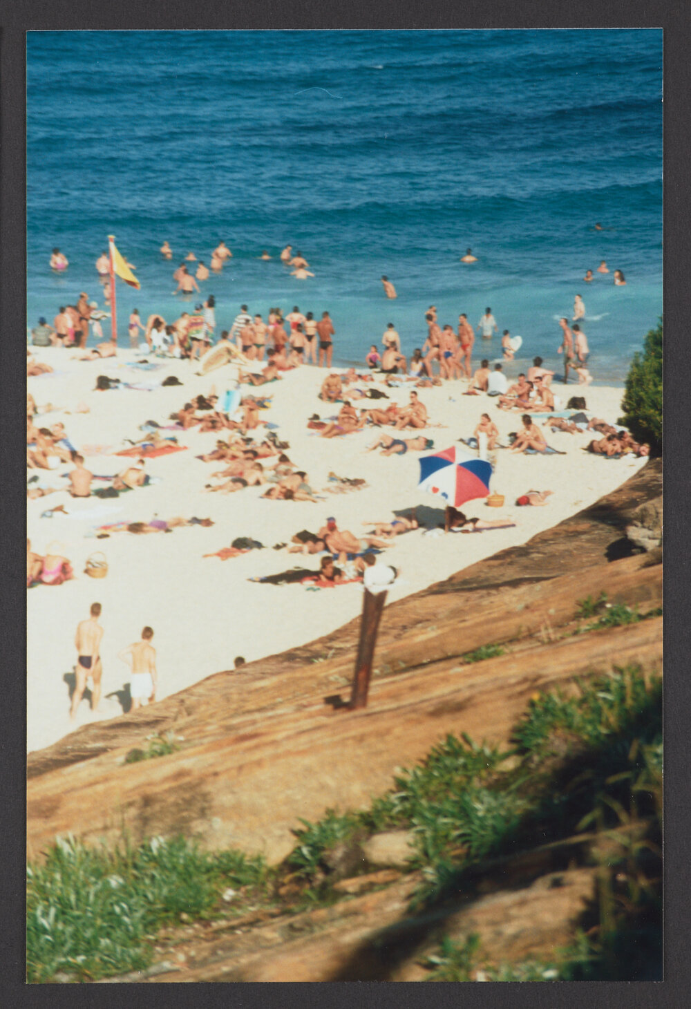 Bathers on Tamarama Beach. Rusty metal spike left over from World War II or Wonderland city amusement park?