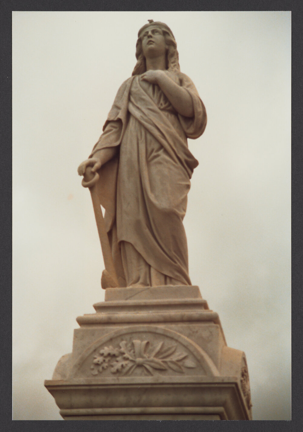 Female figure hand on chest and anchor