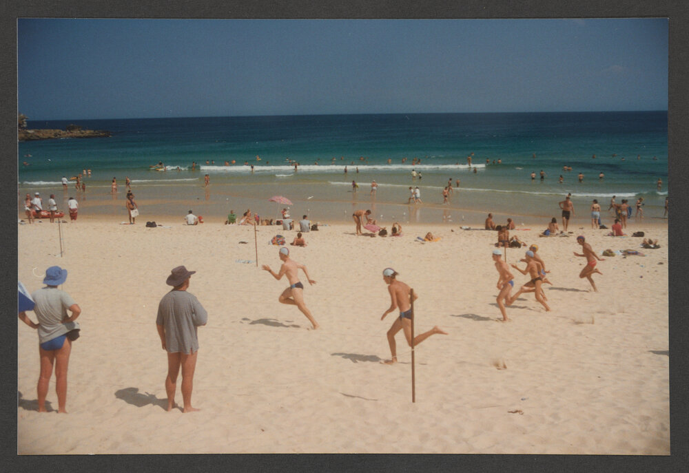 Surf Lifesavers racing on beach.
