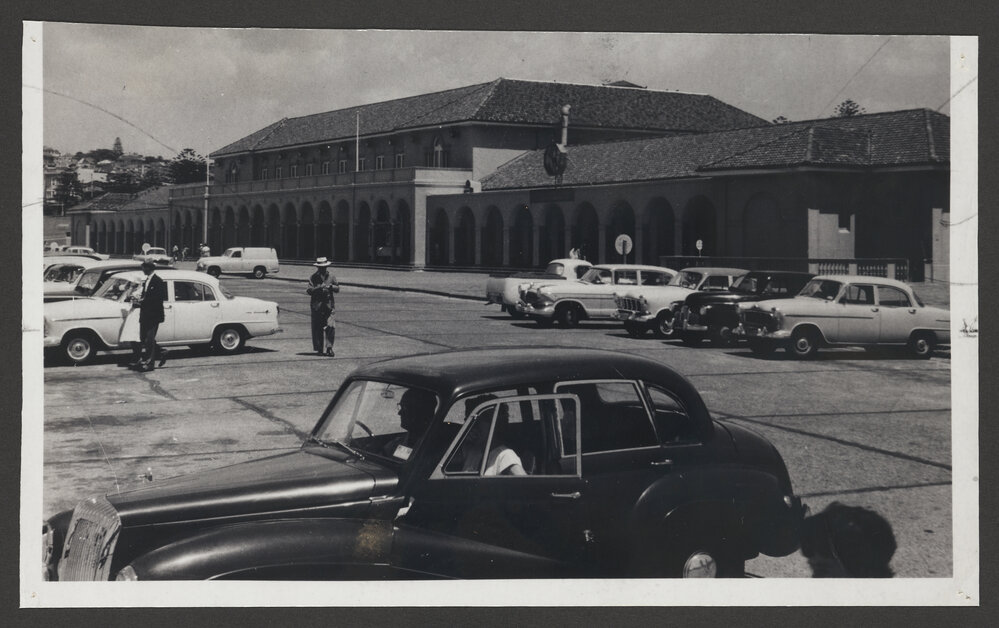 Bondi beach pavilion with cars.