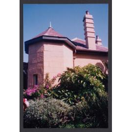 Lawn and flower pot below east ( rear ) verandah.