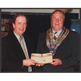 Denis Moore, Library Manager, accepting Fanny Durack autograph book from Graham Murray, president B.J. Rotary Club.