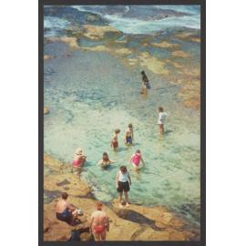 MacKenzie's Bay with people on rocks a swimming in bay.