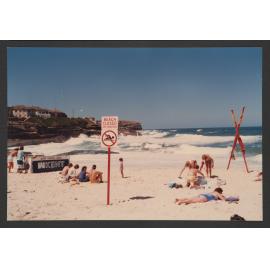 Bronte beach, north end of beach. " Beach closed " sign, with crossed flags. Life savers patrol enclosure.