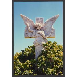 Angel and cross, white marble mirror plant in foreground.