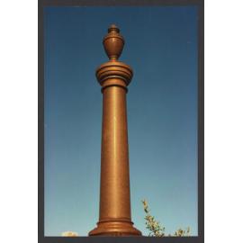 Urn on shroud draped pedestal