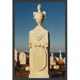 Urn on shroud draped pedestal