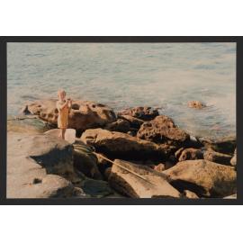Bronte beach, Small boy at bogey hole fishing for crabs.