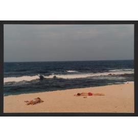 Bronte beach, Two sunbathers on beach, bogey hole to right.