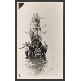 Bathers, Group of bathers form a human pyramid in water.