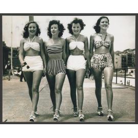Beach girls walking on promenade, Bondi beach : Norma Weston, Monica Kelly, Patty Jupp, Judith ( Judy ) Parnell. Girls aged approx. 16 years old.