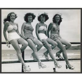 Beach girls sitting on a railing Bondi beach : Norma Weston, Monica Kelly, Patty Jupp, Judith ( Judy ) Parnell.  Girls aged approx. 16 years old.