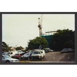 Parking lot with scaffolding in back
