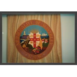 Tapestry of the Municipality seal in council meeting room.