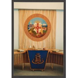 Council chamber meeting room. Mayor's chair and tapestry of Municipality seal.